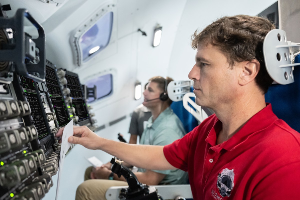 Artemis II astronauts Reid Wiseman and Jeremy Hansen practise with Orion simulator controls; archival training photograph.